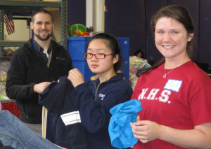 Mr. Wessman of Fontbonne’s Theology department, Jiaqi Shen ‘14 of Quincy, Rebecca Simmons ‘13 of Abington sort clothes at Cradles to Crayons in Brighton.