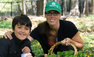 Milton Garden Club president Georgia Lee with son Jae demonstrates how to pick garlic mustard weeds for pesto