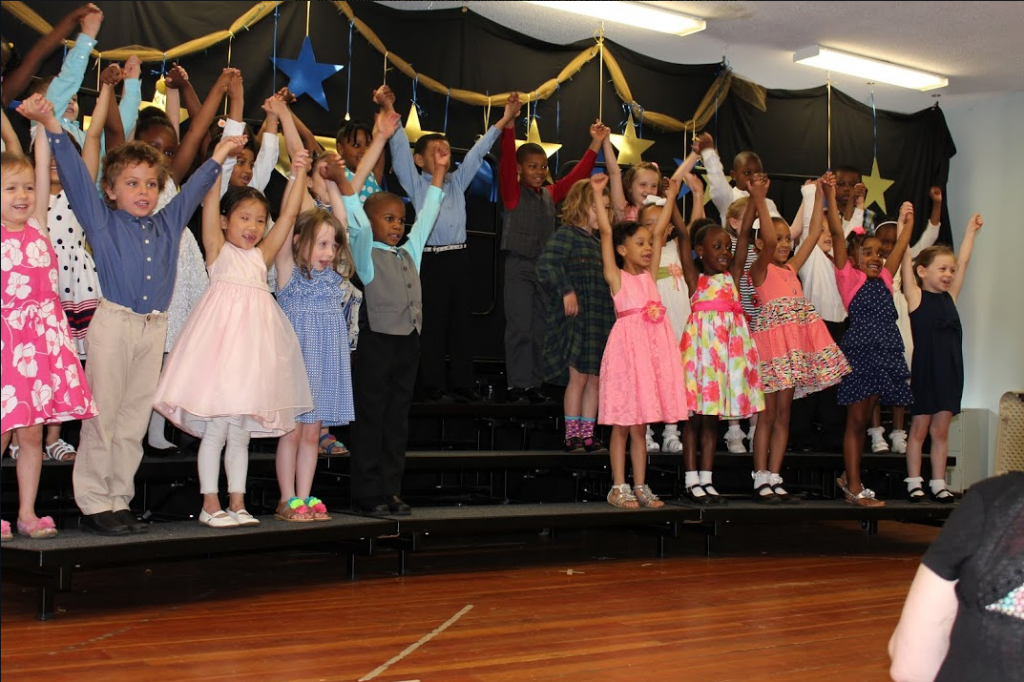 The kindergarten students sing together in front of their families and teachers, as they get ready to move on to the first grade