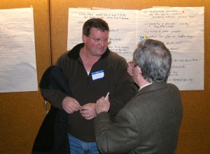 Selectment Sweeney (back to camera) talks with an attendee