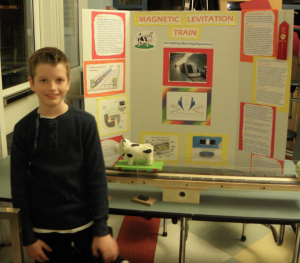 Max Strout with his science fair display, "Magnetic Levitation Train."