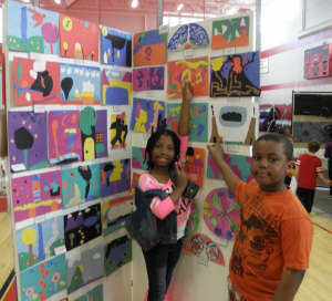 Shenia Mahase and Bentley Hines, both Tucker third-graders, show off their art work