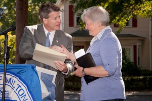 Master of Ceremonies Kathleen O'Donnell, on behalf of the Friends of Crane Field, accepts a citation from Representative Walter Timilty.