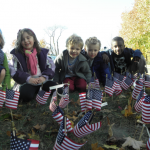 Glover kindergarten students Fiona Tobin, Charlotte Murphy, Dan Sullivan, John Sullivan and Channing Howse plant flags on the front lawn of the Glover Elementary School.