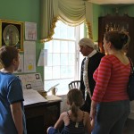 Dr. Joseph Warren (Michael LePage) talking with Jen Palmer and her children Luke and Annie