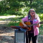 Barbara Ehrmann leading the crowd in song