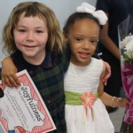 Great friends Caroline Efstathiou (Canton) and Destiny Hartgrove-Collins (Randolph) celebrate together after the graduation. Destiny was presented with the Joyfulness Award.