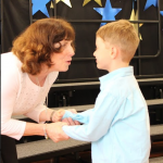 KB teacher, Mrs. Farrell congratulates Thomas Monaghan as he receives the Alertness Award