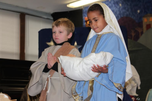 Braeden O'Brien (Milton) and Asmara Quartey (Quincy) play the roles of Joseph and Mary as they hold baby Jesus.