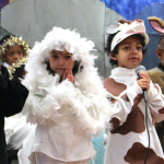 Kindergarteners play the role of the animals in the barn where Joseph and Mary found shelter on Christmas Eve. Left to Right- Isaiah Jeter (Jamaica Plain), Emiliana Zamora (Quincy), Christian Harrigan (Dorcester), and Brandon Williams-Green(Roxbury.)