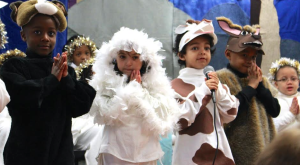 Kindergarteners play the role of the animals in the barn where Joseph and Mary found shelter on Christmas Eve. Left to Right- Isaiah Jeter (Jamaica Plain), Emiliana Zamora (Quincy), Christian Harrigan (Dorcester), and Brandon Williams-Green(Roxbury.)