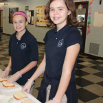 Daniella Cimino of Dedham and Olivia Taveira of Randolph prepare sandwiches for the homeless