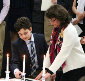 6th grade inductee, Xavier Welch of Milton, signs into the chapter of National Junior Honor Society with Principal, Mrs. Mary Carberry.